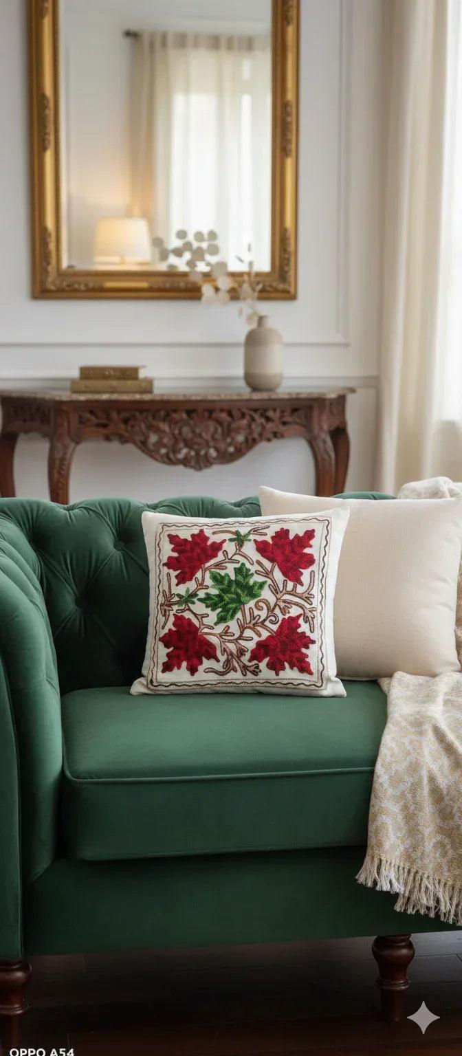Embroidered throw pillow with green and red leaf patterns, perfect for cozy home decor