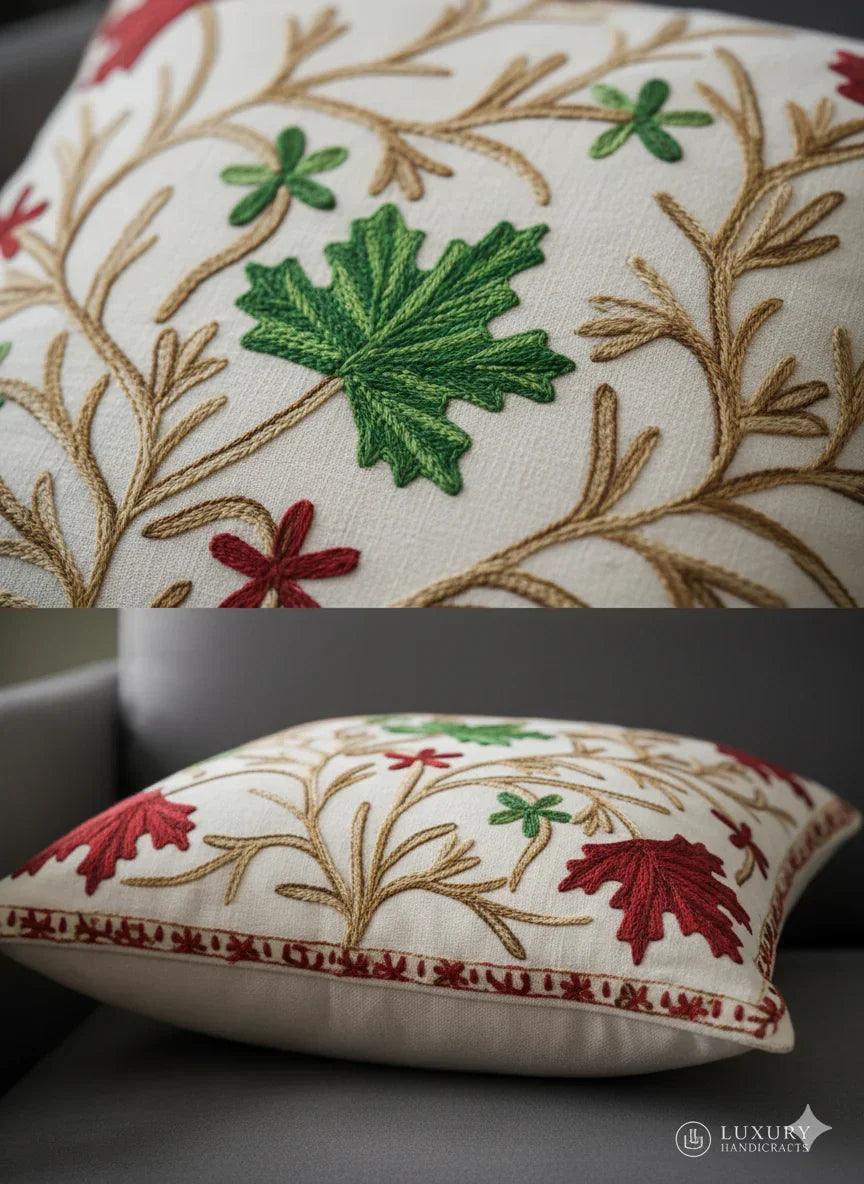 Embroidered throw pillow with green and red leaf patterns, perfect for cozy home decor