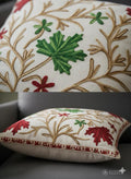 Embroidered throw pillow with green and red leaf patterns, perfect for cozy home decor