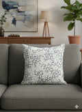 Abstract patterned throw pillow on gray sofa, modern living room decor with art and plant