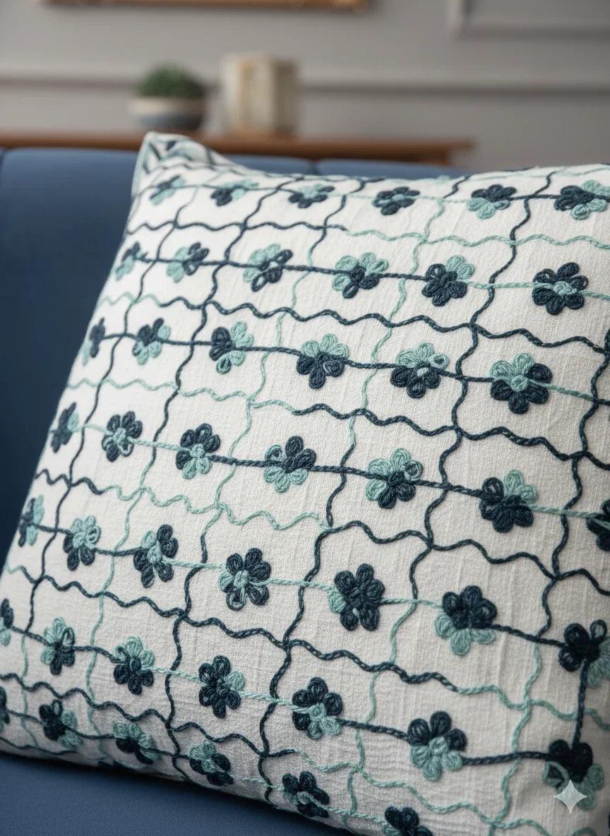 Floral patterned throw pillow on navy blue sofa in modern living room decor
