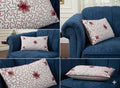 White pillow with red floral embroidery on navy blue sofa, decorative throw pillow for living room