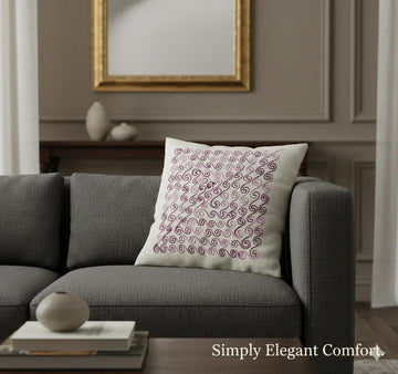 Elegant swirl-patterned throw pillow on gray sofa, adding cozy decor to living room