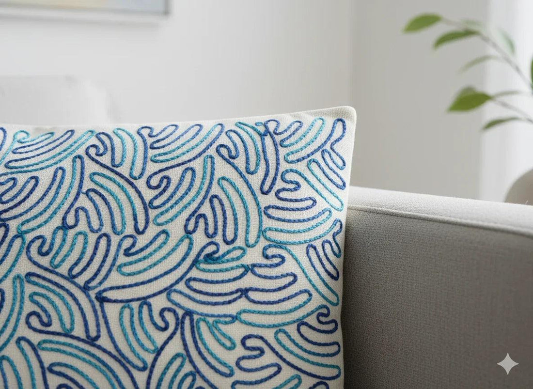 Blue wave pattern decorative pillow on gray sofa, coastal home decor accent